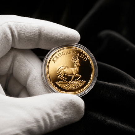 Gloved hand holding a freshly minted gold Krugerrand in a protective capsule to preserve its krugerrand coin price at resale.