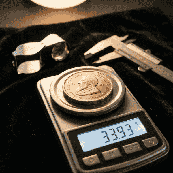 Digital scale showing 33.93g weight to calculate how much is a kruger coin worth in pure fine gold